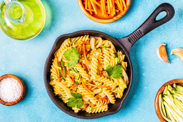 Fusilli pasta with squid, zucchini and carrots