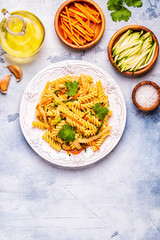 Fusilli pasta with squid, zucchini and carrots