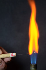 Colored fire caused by an element. Sodium (Na) causes a yellow-orange color.