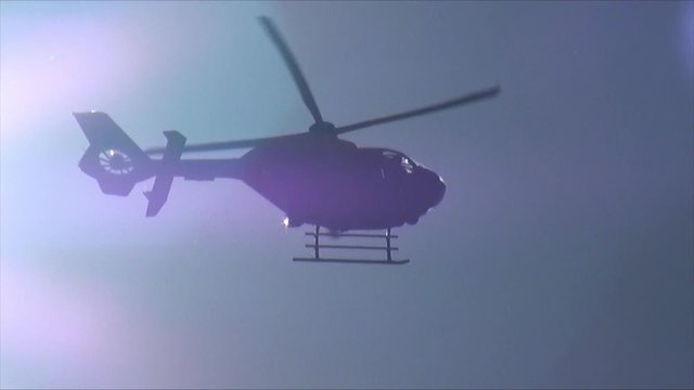 UK October 2011 - A Silhouetted Police Helicopter Passes In Front Of The Sun.