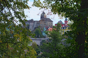 Fototapeta na wymiar Beautiful view of Loket Castle with colorful buildings by summer sunny day. Bohemia, Sokolov, Karlovarsky Region, Czech Republic