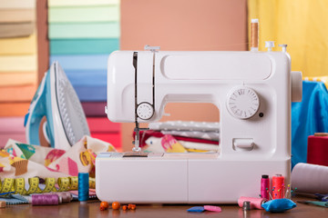 Workplace seamstresses, white electric typewriter, multi-colored fabrics and accessories