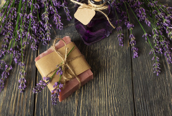 Handmade soap and fresh branches of fragrant lavender on boards