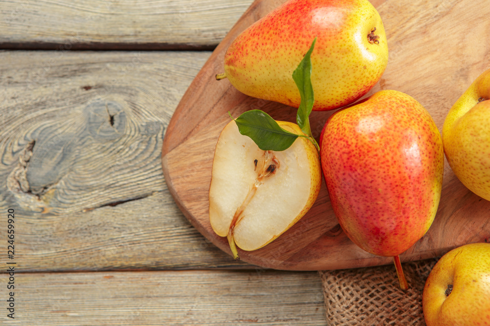 Sticker ripe pears on rustic wooden table