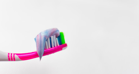 Toothbrush with squeezed toothpaste  on a white background.