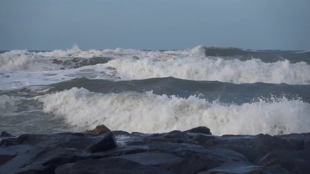 Waves rolling on the beach is a stormy day, winter mediterranean sea. Focene, Lazio, Italy. Slow motion
