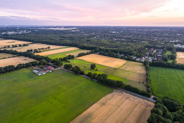 Aerial view of amazing sunset over the park in Germany. Hill and lake from birds eye view.  