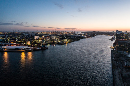 Aerial view of the harbor district, the concert hall "Elbphilharmonie" and downtown Hamburg, Germany, at dusk. 