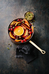 Mulled wine with fruits in saucepan