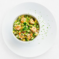 mayonnaise based salad with shrimps, avocado, cucumber, and egg decorated with parsley