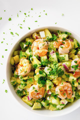 mayonnaise based salad with scampi, avocado, cucumber, and egg decorated with parsley