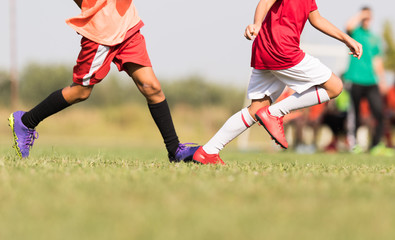 Obraz premium Young childrens player on the football match