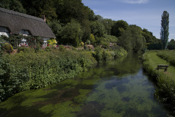 Thatched Cottage beside the River Test, Wherwell, Hampshire, England.