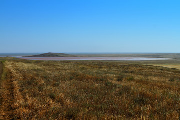 Natural landscape photo of fantastic Kayashskoe lake in Crimea, at the Black sea shore with naturally red water.