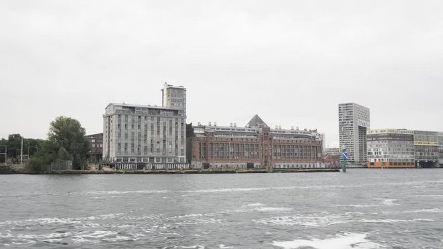 A wide shot of architectual highlights in Amsterdam such as Het Stenen Hoofd and MVDR apartments at the SIlodam.