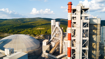 Aerial view of cement manufacturing plant. Concept of buildings at the factory, steel pipes, giants.