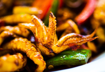 Fried squid with vegetables on a plate