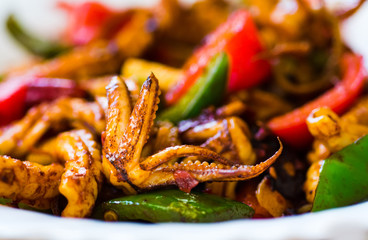Fried squid with vegetables on a plate