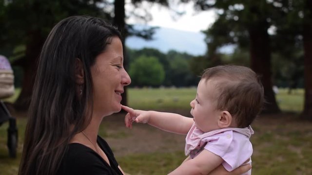 Slow motion a baby developing senses by touching its mother&not;&yen;s month