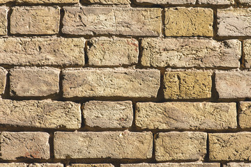 grey grungy brick wall with sunlight