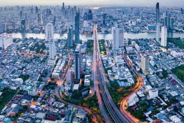 Aerial view of Bangkok skyline panorama and skyscraper with light trails on Sathorn Road center of business in Bangkok city Thailand.