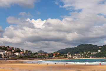 View of the wide sandy beach on the ocean coast in the Spanish city of San Sebastian
