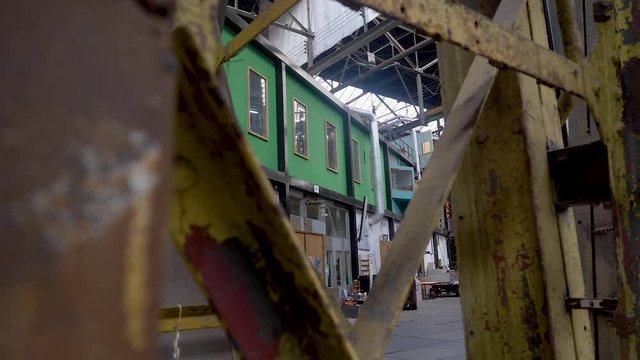 A slow push out showing the industrial warehouse of the NDSM Loods.