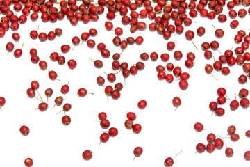 .A scattering of red berries on a white isolated background