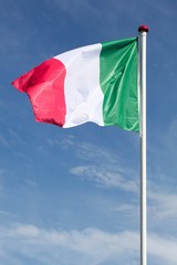 Naklejka na ściany i meble Flag of Italy waving in the sky