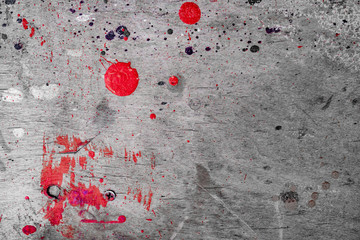 an old gray wall with spots of red paint