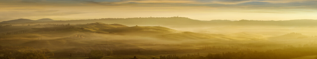 Idyllic view, foggy Tuscan hills in light of the rising sun