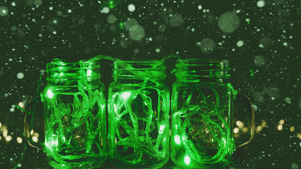 green lights in glass transparent jars snow Christmas lights in the room