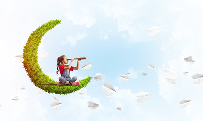 Concept of careless happy childhood with girl on green moon