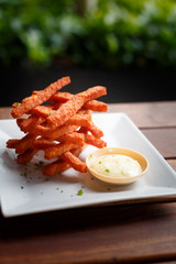 Food photography close up shot sweet potato fries with dipping sauce served on white plate