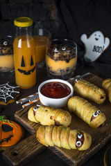 Halloween food assortment - sasage mummies, pumpkin dessert, gin