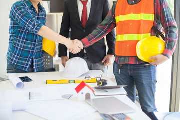 Concept Agreement between the employer and architect Nick and desk of Architectural project in construction site 