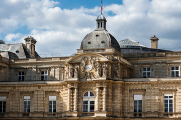 Fototapeta na wymiar Paris, France - August 13, 2017. Close up view of Luxembourg Palace, now is home to French Senate. Popular parisian landmark, historic building with molding, clocks and sculptures.