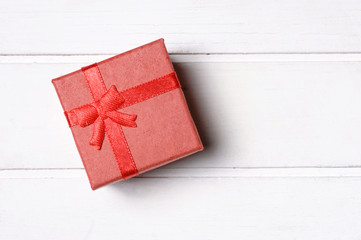 Gift box on wooden background.