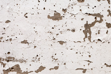 plastered brick wall with crumbling plaster