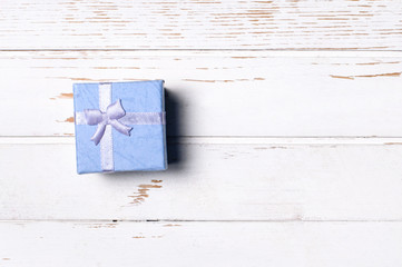 Gift box on wooden background.