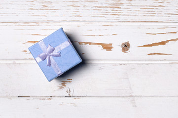 Gift box on wooden background.