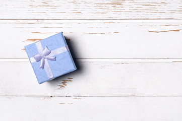 Gift box on wooden background.