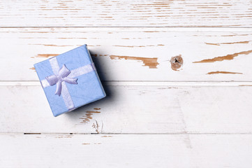 Gift box on wooden board.