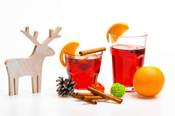 Winter beverage concept. Traditional winter beverage with cinnamon sticks and orange fruit. Glasses...