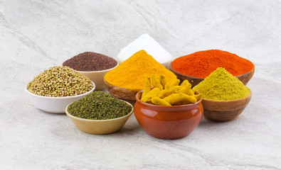 Indian Spices Collection Also Called Red Chili Powder, Turmeric Powder, Coriander Powder, Fenugreek, Mustard Seed, Salt, Turmeric Stick, Mirchi, Haldi, Dhaniya, Methi on Vintage Background