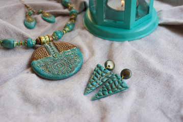 Indianbohemian style jewelry with tuquoise gold necklace and earrings. Fashion jewelry. Turquoise color  background.