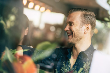 group of multi nation friends enjoy conversation with fun and happiness meeting business casual ideas concept with cafe restaurant background