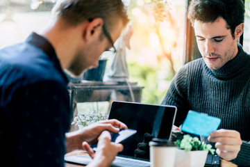 two smart caucasian man meeting and consult with serious and focusing conversation near window cafe background