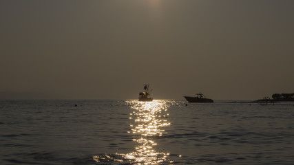 Fototapeta premium View of the sunset by the sea with ship (2)
