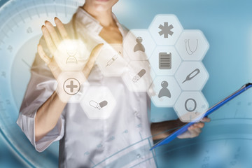 Medical concept of futuristic health care technology and augmented reality. A female doctor hand is touching a virtual innovative control panel to monitor a patient's electronic health records
